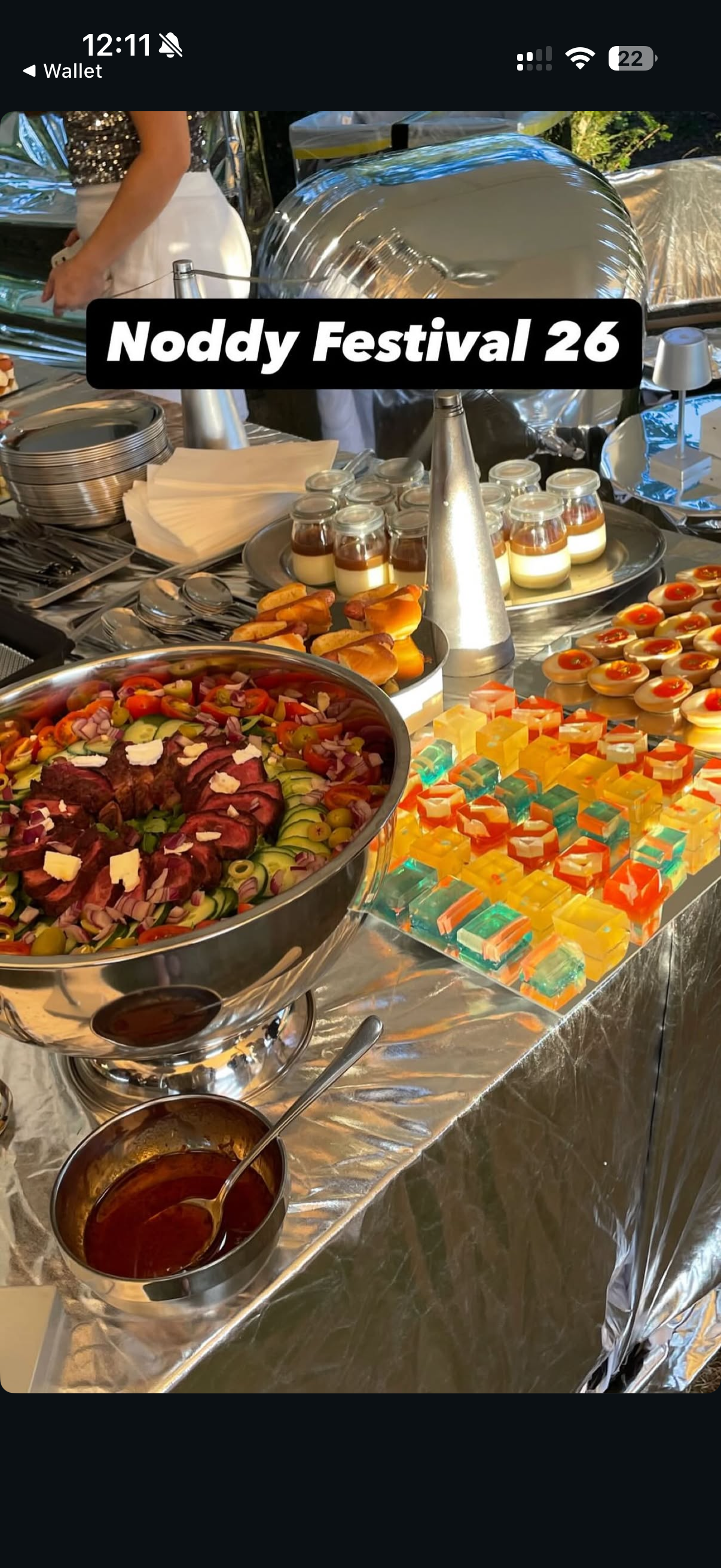 Mirror-clad banquet table dressed with food and glassware