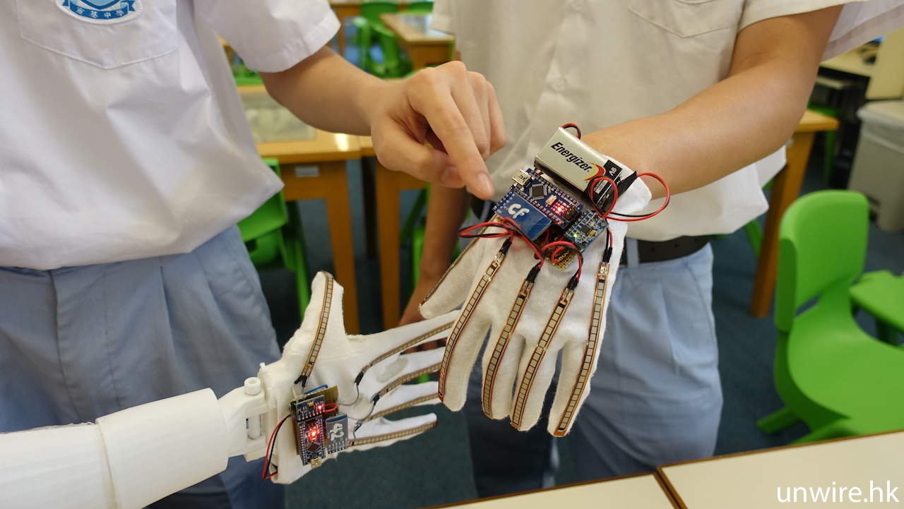 Sensor glove with flex strips along each finger, wired to a microcontroller at the wrist